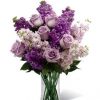Lavender colored flowers and roses for Valentines day in a clear vase